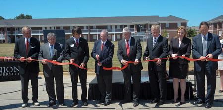 Jerry Gist, Frank Wagster, Micah Roeder, President David S. Dockery, Ken Brasfield, Rod Parker, Kimberly Thornbury, and Gary Carter participate in the ribbon cutting ceremony for the Hope Residence Complex.  - Photo by Morris Abernathy