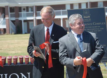 Jerry Gist, mayor of Jackson, and Frank Wagster of TLM & Associates laugh together after the ribbon cutting in from of the Hope Residence Complex.  - Photo by Morris Abernathy