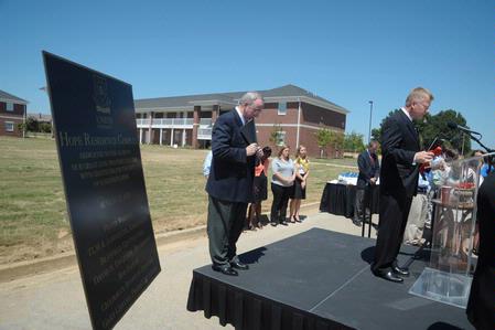 Rod Parker, chairman of the board of trustees, leads in the benediction after the dedication of the Hope Residence Complex.  - Photo by Morris Abernathy
