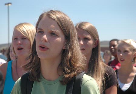 Rebecca Thomas, sophomore elementary education and TESL double major, sings along with others in attendance at the dedication of the Hope Residence Complex.
 - Photo by Beth Spain