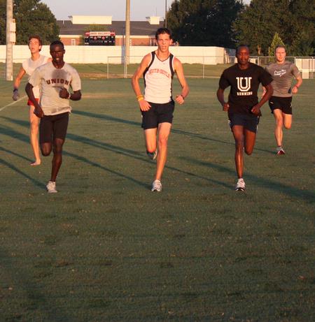 The men's cross country team practices for the fall season. - Photo by Ebbie Davis
