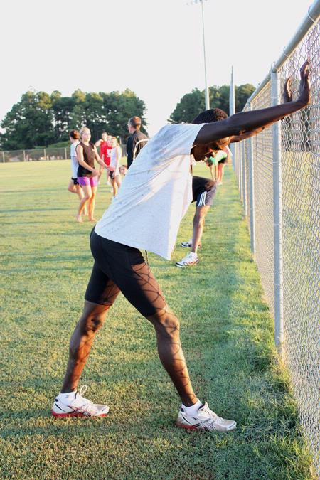 Alex Bett, junior TranSouth individual champion, stretches after a morning practice. - Photo by Ebbie Davis