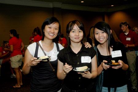 Ming Tay, junior broadcast journalism major, May Lee, junior nursing major, and Kendra Loh, freshman psychology major, eat their desserts together at the SGA/President's Reception. - Photo by Deanna Santangelo