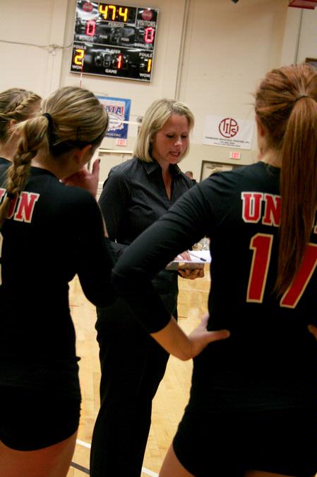 Kelly Elliot, head coach, talks with the volleyball team during a time out in a match against Lyon College. The Lady Bulldogs won 3-1.  - Photo by Deanna Santangelo