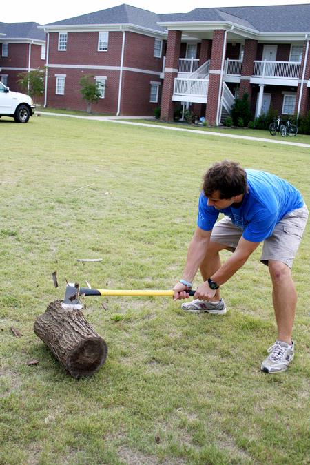 Aaron Daigle, senior social work major, tests out the freshly sharpened axe before the games begin at the Watters Great Outdoors competition.
 - Photo by Deanna Santangelo
