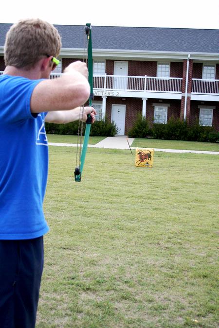 Wade Evans, junior physical education and health major, competes in the archery category for his team during the Watters Great Outdoors event. - Photo by Deanna Santangelo
