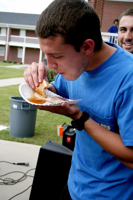 Casey Kidd, senior Christian studies major, eats as many pancakes as he can for his team during the Watters Great Outdoors competition. - Photo by Deanna Santangelo
