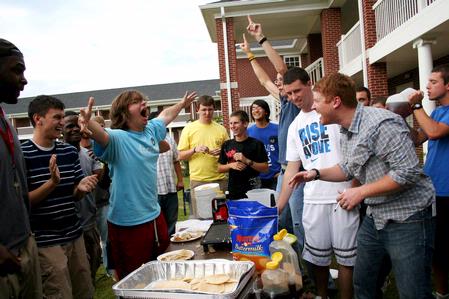 Zachary Preston, sophomore TESL major, celebrates after winning the pancake eating competition at the Watters Great Outdoors event.
 - Photo by Deanna Santangelo