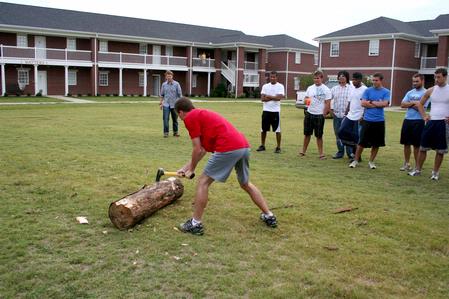Zachary Key, junior medical technology major, works hard to split a log for his team during the log splitting portion of the Watters Great Outdoors event. - Photo by Deanna Santangelo