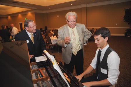 Larry Vaughn, assistant to the senior vice president of university relations, and Dennis Swanberg talk to Sam Ritter, junior music major, before the West Tennessee Pastors Appreciation Banquet. - Photo by Morris Abernathy