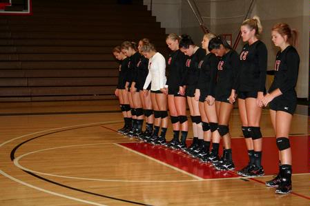 The Lady Bulldog volleyball girls bow their heads for prayer before a game against Martin Methodist. - Photo by Deanna Santangelo