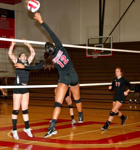 Marcela Madeira spikes the ball over the net during a game against Martin Methodist, which the Lady Bulldogs won 3-1 - Photo by Deanna Santangelo