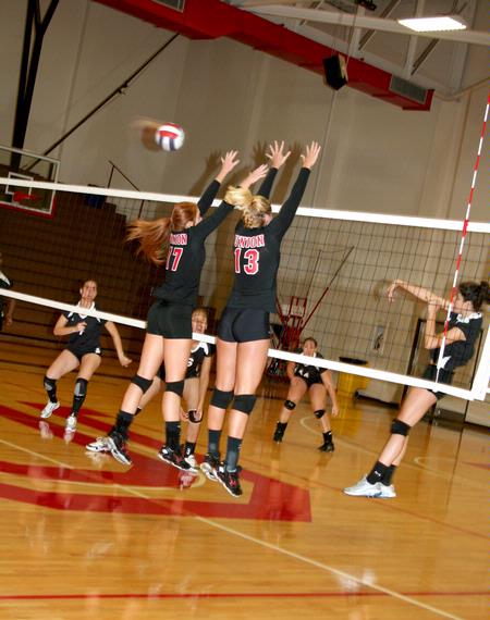 Ana Sims and Caroline Robbins jump to block the ball against Martin Methodist. The Lady Bulldogs won 3-1. - Photo by Deanna Santangelo