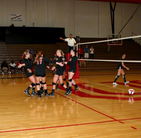 The Lady Bulldog volleyball team celebrates scoring against Martin Methodist. - Photo by Deanna Santangelo