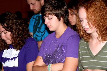 Art majors Katherine Crutcher, Kristen Marks, and Michele Marks bow their heads in prayer during chapel. - Photo by Deanna Santangelo