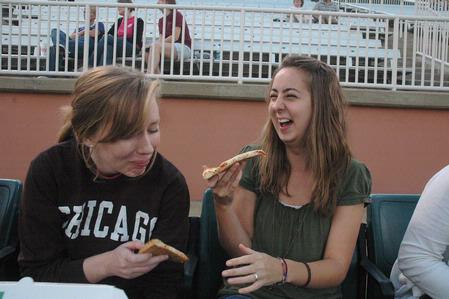 Sophomores Taylor Glover, nursing major, and Miranda Jackson, elementary education major, laugh together during the West Tenn Diamond Jaxx Union Night at Pringles Park.  - Photo by Beth Spain