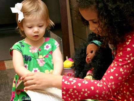 Norah-Kate Carothers, daughter of David Carothers, and Hailey Jackson, daughter of Paul Jackson, play together at Go Week: Reaching the Nations through Adoption.  - Photo by Deanna Santangelo