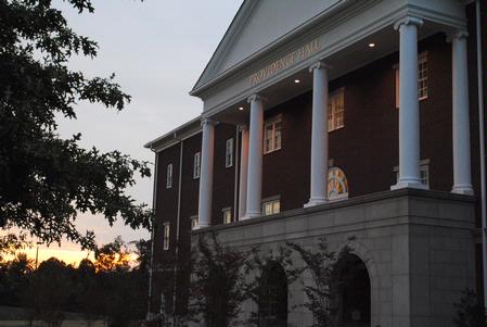 The sun sets behind Providence Hall on a late summer day.  - Photo by Victoria Stargel