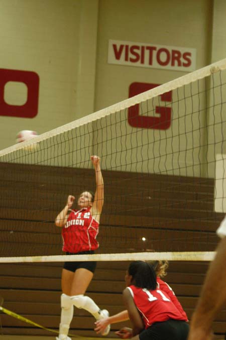 Crystal Abel (12) takes a swing.  Abel is a senior this year and is among the leaders in kills and blocks. - Photo by Steven Aldridge