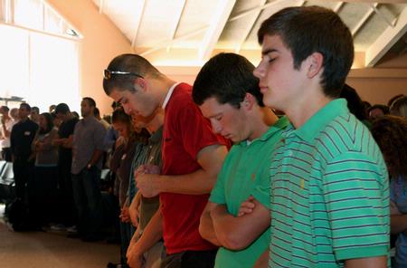 Joey Davis, freshman, gathers with other Union students for prayer during GO Week chapel. - Photo by Ebbie Davis
