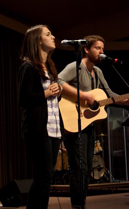 Natalie Wittman, junior English major, and TJ Hester, junior philosophy major, lead students in music at a Global Outreach chapel. - Photo by Ebbie Davis