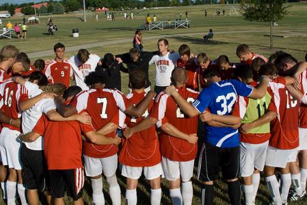 Union men's soccer prays after a match. - Photo by Meagan Comeaux