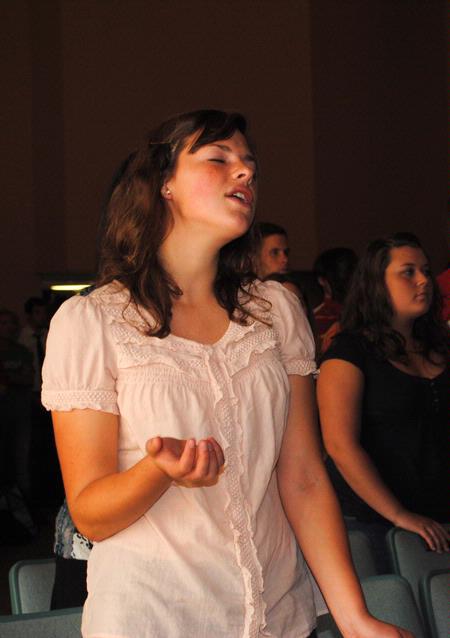 Jenny Voss, freshman applied linguistics major, sings along to "It is Well" during a chapel service. 
 - Photo by Victoria Stargel