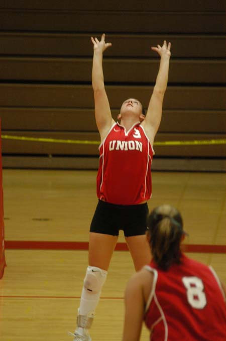 Junior setter Nicole Garber (3) sets up one of her teammates.  Jennie Glassey (8) looks on. - Photo by Steven Aldridge