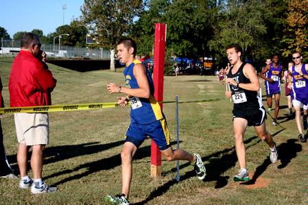 Joel Wellum, senior political science major, rounds a corner in a cross country race.  - Photo by Deanna Santangelo