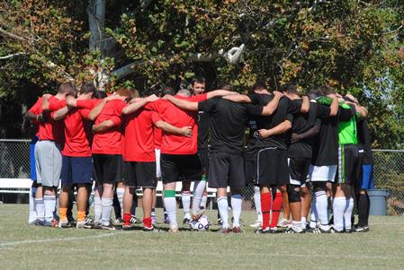 Union soccer alumni huddle with the bulldog jv soccer team before playing a game against each other.  - Photo by Victoria Stargel