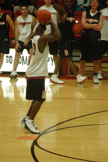 Senior guard Zach Wiggs takes a shot during the Hot Shot competition as his teammates watch. - Photo by Courtney Ross