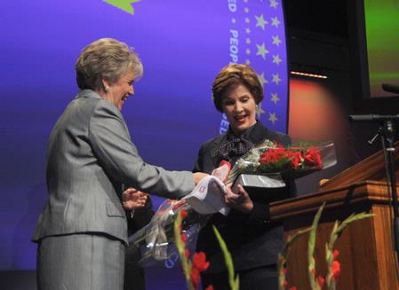 Lanese Dockery, first lady of Union University, thanks Laura Bush, former first lady of the United States, for speaking at the 13th annual Scholarship Banquet and presents her with roses.  - Photo by Morris Abernathy