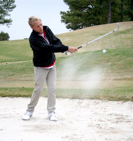 Jesper Swedenborg, junior business major, practices his putting during a Union golf practice.  - Photo by Deanna Santangelo