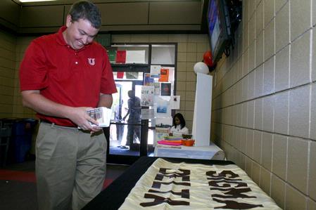 Steven Aldridge, director of sports information, sets up the table for PEWS at Career U. - Photo by Deanna Santangelo