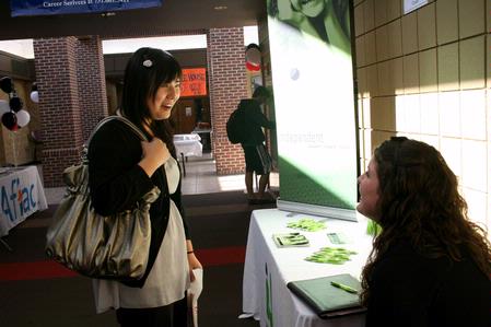 Shinae Giffin, junior art major, talks with Mallory Allen, alum, during Career U, which was held in the SUB hallway.  - Photo by Deanna Santangelo