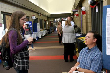 Shea Wingate, freshman, talks with Michael Salazar, associate professor of chemistry, during Career U, hosted by Career Services.  - Photo by Deanna Santangelo