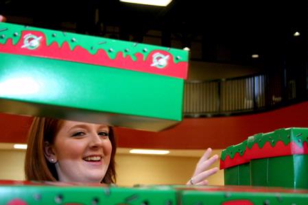 Ericka King, senior political science major, stacks completed Operation Christmas Child boxes during Campus and Community Day. - Photo by Deanna Santangelo