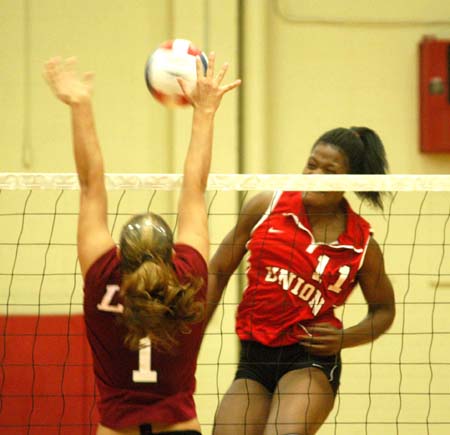 Gladys Wandera (11) elevates for one of her game high 23 kills during a loss to Lee. - Photo by Steven Aldridge