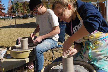 Art majors Phillip Baker and Lori Landon created and sold pottery on the Great Lawn during Arts in the Park. - Photo by Abigail Harris
