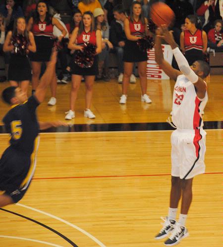 Union Bulldog Antoine Hall shoots over the head of his Truett-McConnell College opponent in the homecoming game. The Bulldogs emerged with a victory of 79-69. - Photo by Victoria Stargel