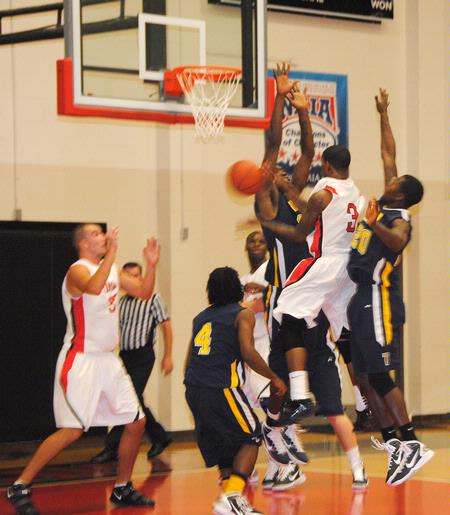CJ Davis fights through his Truett-McConnell College opponents for a shot during the homecoming game.  - Photo by Victoria Stargel