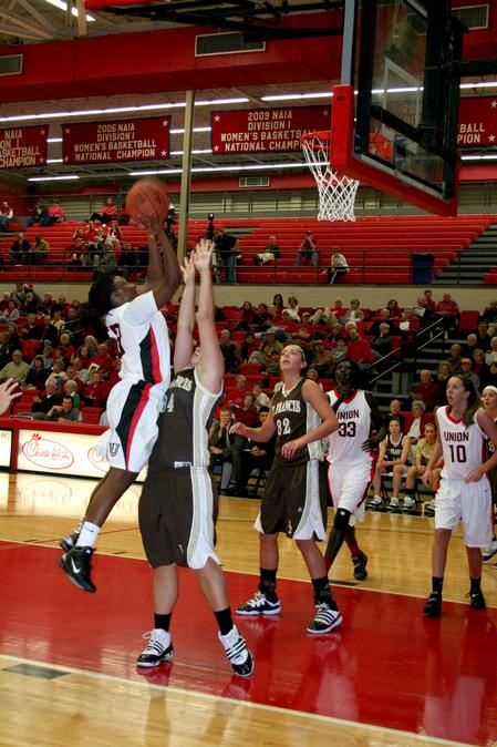 Lavanda Ross jumps over her University of St. Francis opponents for a shot in the homecoming game. The Lady Bulldogs won the game 83-57.  - Photo by Deanna Santangelo