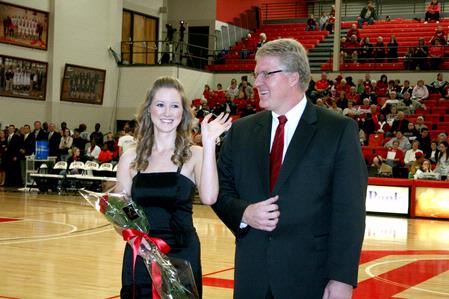 Ashley Smith, freshman business administration major, is escorted by her father, Tim Smith, dean of the School of Nursing, during the presentation of the homecoming court.  - Photo by Deanna Santangelo