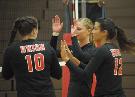 Union players celebrate after a point. Shelby Swink (10), Emmie Moroski (middle), Marcela Madeira (12). - Photo by Morris Abernathy