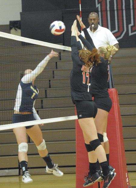 Anna Sims and Caroline Robbins go up for the block. - Photo by Morris Abernathy