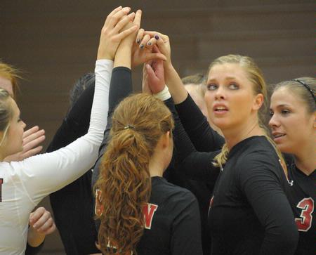 Emmie Moroski and the Lady Bulldog volleyball team get ready to go back on the court after a timeout.  - Photo by Morris Abernathy