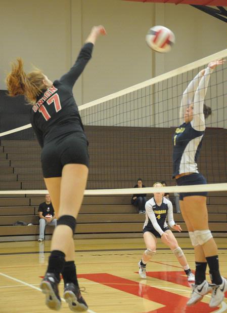 Anna Sims spikes the ball. - Photo by Morris Abernathy