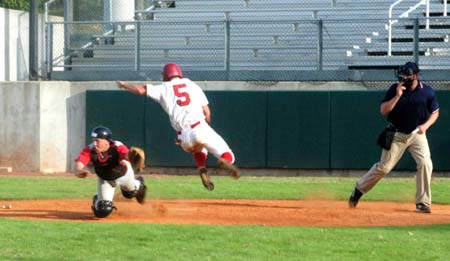 Sophomore Steve Sweat leaves his feet to avoid a possible tag by catcher Zach Lowery during the Intersquad World Series. - Photo by Steven Aldridge