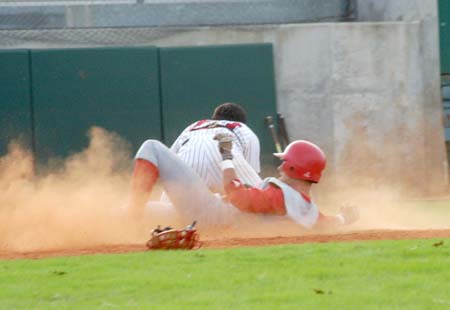 Jason Johnson stirs up dust with his slide into home to score a run during the Intersquad World Series. - Photo by Steven Aldridge