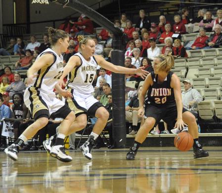 Kayla Hudson dribbles around 2 Vanderbilt players in the exhibition game in Nashville.  - Photo by Morris Abernathy